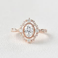 a rose cut diamond engagement ring on a white surface