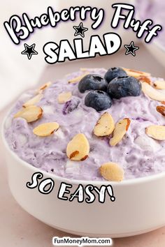 a bowl filled with blueberries and almonds on top of a table