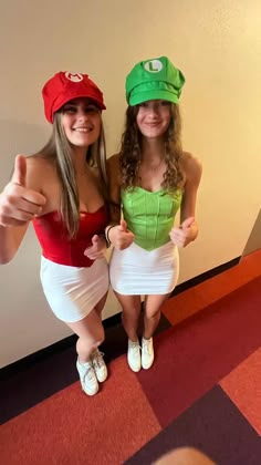 two women dressed up in costumes posing for the camera