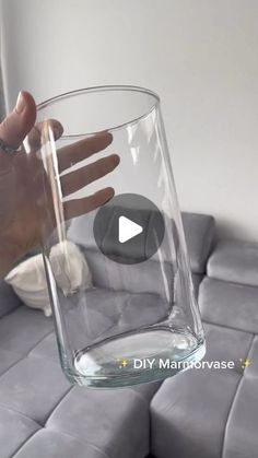 a person is holding a glass with water in it and the video below shows how to make an upside down vase