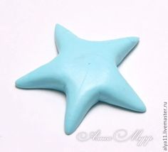 a blue star shaped object sitting on top of a white table