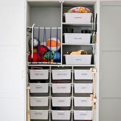 an organized closet with plastic bins and baskets