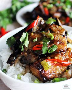 a white bowl filled with rice and meat