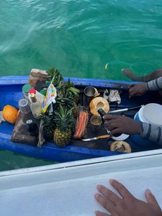 two people in a blue boat with food on it