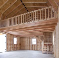 an empty room with wooden walls and stairs