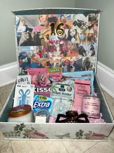 an open suitcase filled with various items on the floor and pictures behind it that say 16