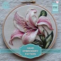 a hand embroidery pattern with pink flowers on white fabric and text that says hand embroidery pattern