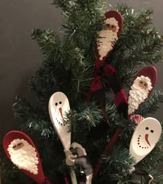 wooden spoons decorated as santa and snowmen in a christmas tree