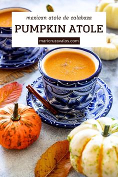 a cup of pumpkin atole sitting on top of a table