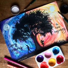 an art project with watercolors, paint and pencils on a wooden table