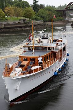 a large white boat traveling down a river