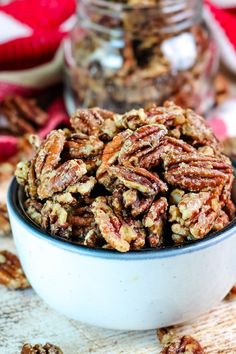 a bowl filled with pecans sitting on top of a table