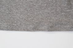 the back of a gray shirt with white buttons