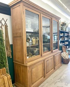 a display case in a store filled with lots of wooden furniture and decorations on shelves