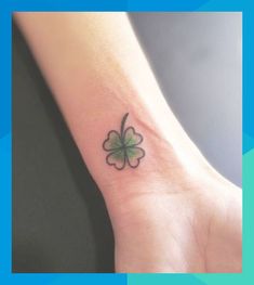 a small four leaf clover tattoo on the wrist