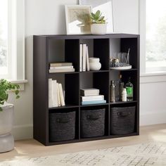 a living room with a couch, chair and bookcase