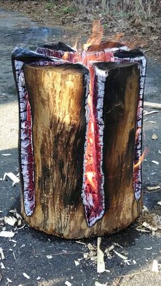 a piece of wood that has been turned into a fire pit with flames coming out of it