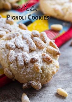 a close up of a cookie with powdered sugar on top and peanuts in the middle