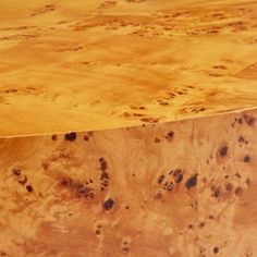 a close up of a wooden table with holes in the wood and black spots on it