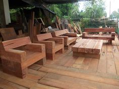 several wooden benches sitting on top of a wooden deck