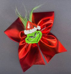 Beautiful Grinch Cheer bow made with 3 inch solid shinny ribbon and a grinch shaker. Grinch Headband, Grinch Bow, Grinch Christmas Tree Bows, Grinch Headband Disney, Grinch Bow Tree Topper, Christmas Cheer Bows, Nightmare Before Christmas Wreath, Softball Bows, Christmas Hair Bows