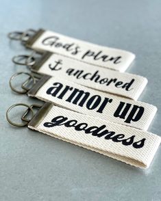 three keychains with words on them that say god's plan to anchored armor up goodness