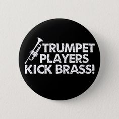 a black button that says trumpet players kick brasss on the front and back of it