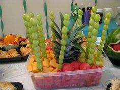 a table topped with trays of fruit and veggies