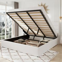 an open white bed frame in a living room