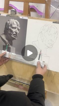 a person is drawing on a piece of paper