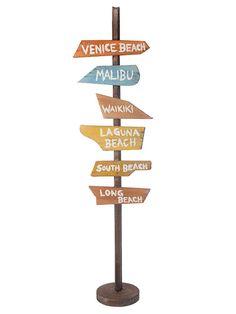 a sign post with many different signs on it's sides and the words venice beach, waiki, waiki beach, south beach, long beach, long beach, long beach