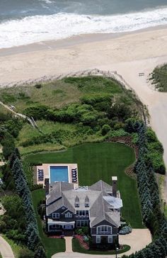 an aerial view of a large house near the beach