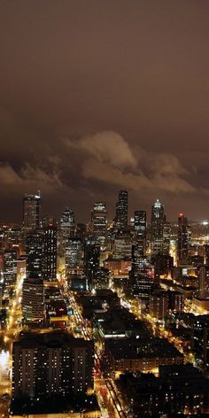 the city lights shine brightly at night in this aerial view from an observation point on top of a tall building