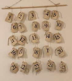 the numbers are hanging on strings with twine and burlap tags attached to them