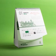 a desk calendar sitting on top of a green surface