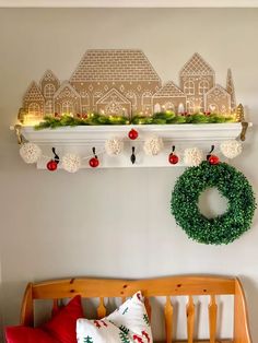 a wooden bench sitting in front of a christmas wreath on top of a wall next to a window