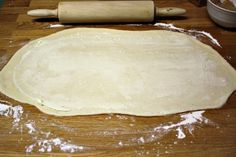 the dough is ready to be rolled out on the table with a rolling pin next to it