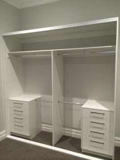 an empty white closet with drawers and shelves