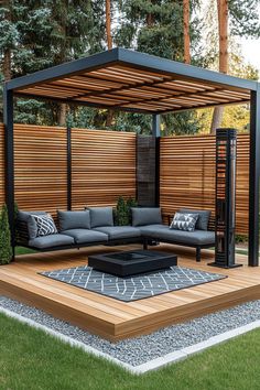 an outdoor living area with couches, tables and a fire pit in the middle