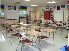 an empty classroom with desks and chairs