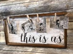 this is us hanging on a wooden wall with clothes pins and pictures attached to it