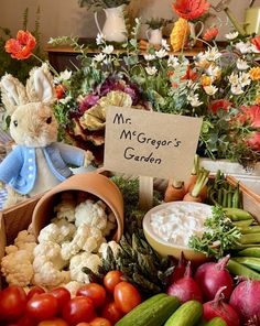 a table filled with lots of different types of fruits and vegetables next to a sign that says mr george's garden