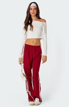 These track pants offer both style and comfort, making them perfect for a sporty yet fashionable look. They're ideal for any activity, ensuring you feel comfortable and confident throughout your entire day.Track pantsSide stripe detailingRibbon tie ankle detailElastic waistPolyesterModel wears size SModel height is 5'7Item care: Wash with similar color Edikted Womens Remy Bow Ribbon Track Pants - Red size XL Red Pants Women, Long Sweatpants, Y2k Sweatpants, Hip Hop Pants, 2000s Clothes, Striped Pant, Track Pants Women, Asymmetric Neckline, Ankle Length Pants