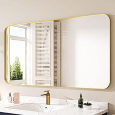 a bathroom sink with a large mirror above it