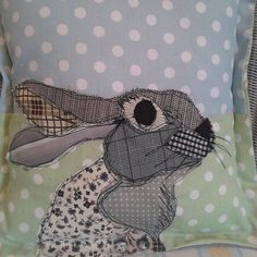 a decorative pillow with an image of a rabbit on it's face and polka dots