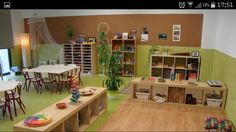 a room filled with lots of tables and chairs next to a book shelf full of books