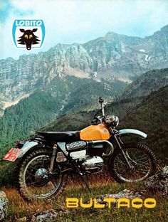 a yellow and black motorcycle parked on top of a mountain