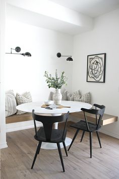 a white table with black chairs in a room