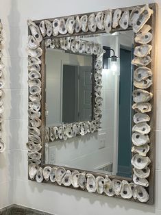 a mirror that is on the wall above a sink