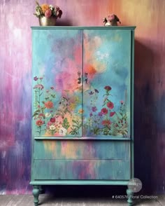 a painted cabinet with flowers on it